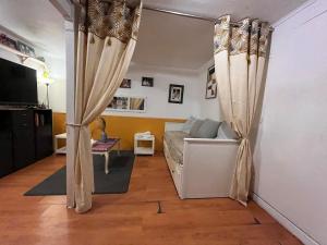 a living room with a couch and curtains at l'atelier in Colomiers +13 photos