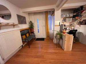 a living room with a wooden floor and a door at l'atelier in Colomiers