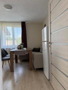 a kitchen with a table and a refrigerator in a room at The Walnut Nest in Sapareva Banya