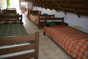 a row of beds in a room with at Complejo Orejano in Mercedes