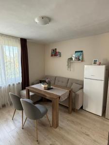 a living room with a couch and a table and a refrigerator at The Walnut Nest in Sapareva Banya