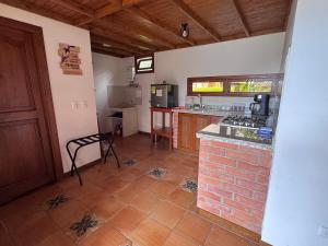a kitchen with a stove and a counter top at Kumanday Lodge in Pereira