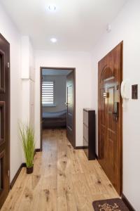 a hallway with wooden floors and a door at Kolbi Signature Platinum Residence in Białogard
