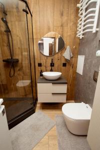a bathroom with a sink and a shower at Kolbi Signature Platinum Residence in Białogard