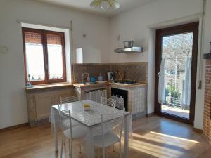 a kitchen with a table and chairs in a room at alloggio turistico olmata in Montevirginio