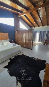 a bedroom with a bed and a t shirt on the floor at Complejo La Conquista in Goya