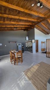 a living room with a table and wooden ceilings at Complejo La Conquista in Goya