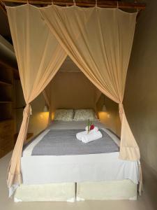 a bed in a tent with a towel on it at MAHAGUA Casa Holística - Jambreiro, Caraiva, BA in Porto Seguro