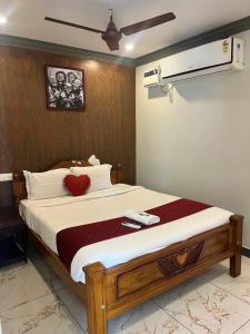 a bedroom with a bed with a red heart on it at Serenity Sunrise Beach Resort in Pondicherry