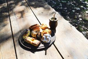 a plate of food on a wooden table at Casa del monte in Carmen de Areco