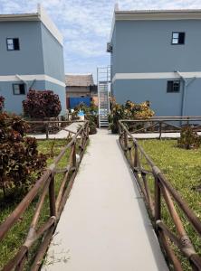 a walkway leading to a building with a fence at Wayma Paradise Resort in Jambiani