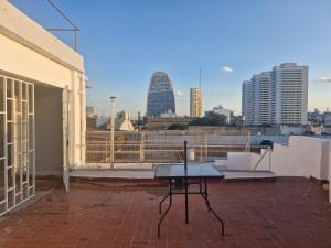 a table on a balcony with a view of the city at Alojamiento La Liboria, solo mujeres in Córdoba