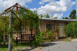a wooden house with a bench in front of it at Complejo Orejano in Mercedes