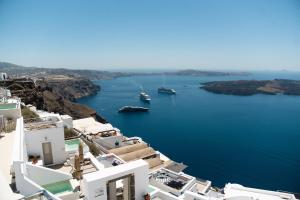 a view of a harbor with boats in the water at Ventus Paradiso Villa in Imerovigli +86 photos