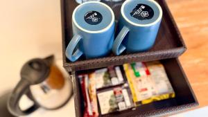 a shelf with two blue coffee mugs on it at Moonlight Sanur in Sanur