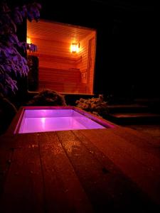 a hot tub is lit up in the dark at Chalupa pod Zubštejnem in Bystřice nad Pernštejnem