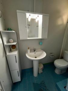 a bathroom with a sink and a toilet at Elia’s house in Ligia +24 photos