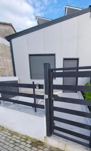 a black fence and a bench next to a building at MAG - Rooms and Apartment in Castelpoto