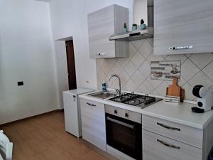 a kitchen with a sink and a stove top oven at Valle degli Alburni in Postiglione +21 photos