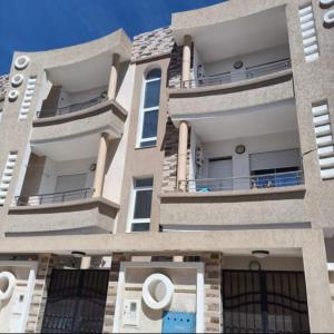 a large building with balconies on the side of it at Dar-Dhiafa Mayar in Mahdia