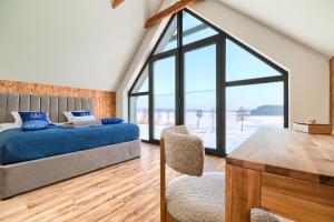 a bedroom with a bed and a large window at "Wioska Wakacyjna Glamila" Mazury, nad jeziorem, podgrzewany basen, Glamping i domki rodzinne in Sterławki Wielkie +167 photos