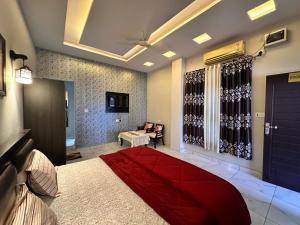 a bedroom with a large red bed in a room at Hotel Tulsi in Haldwāni