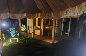 a house at night with a chair and an umbrella at Gîte privatif avec spa, sauna à Colmar in Logelbach