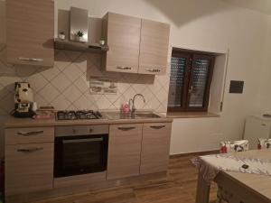 a kitchen with a sink and a stove top oven at Valle degli Alburni in Postiglione