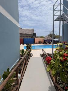 a walkway leading to the pool at a resort at Wayma Paradise Resort in Jambiani