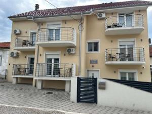 a building with balconies and tables and chairs on it at Studio nikola in Soko Banja