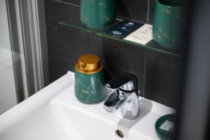 a bathroom sink with a faucet on top of it at Hotel Haus Hohne in Hohne