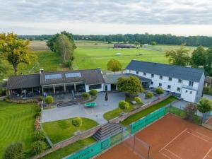 an aerial view of a house with a tennis court at Hotel Haus Hohne in Hohne
