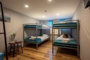two bunk beds in a room with a table at Hotel Haus Hohne in Hohne +9 photos