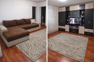 a living room with a couch and a tv at Apartament Magic Petroșani in Petroşani