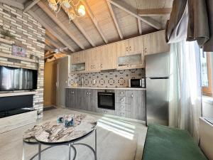 a large kitchen with a table and a refrigerator at Bloom Garden 3 in Mytilene +13 photos