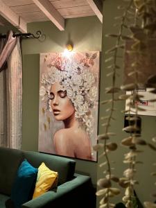 a painting of a woman with flowers on a wall at Bloom Garden 3 in Mytilene
