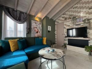 a living room with a blue couch and a table at Bloom Garden 3 in Mytilene