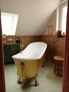 a clawfoot tub in a bathroom with a attic at Le Banellou in Quimper