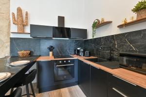 a kitchen with blue cabinets and a counter top at Terra Solis in Craponne