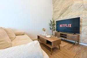 a living room with a tv and a couch at Terra Solis in Craponne