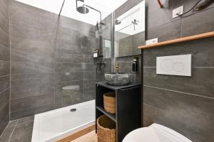 a bathroom with a sink and a toilet and a shower at Terra Solis in Craponne