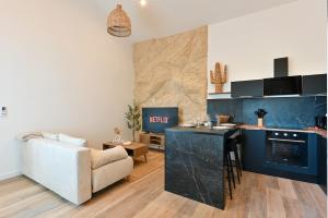 a kitchen and living room with a couch and a table at Terra Solis in Craponne +6 photos