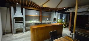 a restaurant with a counter and a sink in a room at Apartamento Maré Alta in Tamandaré