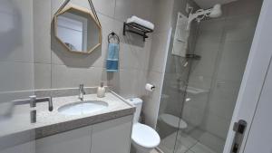 a bathroom with a sink and a toilet and a shower at Apartamento Maré Alta in Tamandaré +17 photos