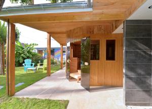 a wooden pergola with a bench on a patio at Gîte privatif avec spa, sauna à Colmar in Logelbach