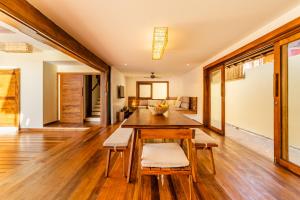 a dining room with a wooden table and chairs at Villa Shamsa - Grupo Messina in Jericoacoara