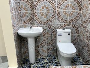 a bathroom with a toilet and a sink at Scarlett Near Mount Zion Laguit Padilla in Bugallon +31 photos