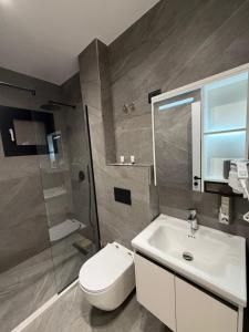 a bathroom with a toilet and a sink and a shower at Velour Boutique Hotel Durres in Durrës +13 photos