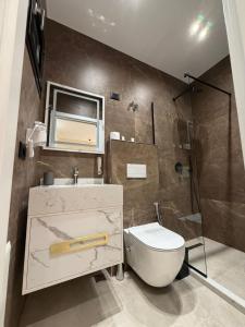 a bathroom with a toilet and a sink and a shower at Velour Boutique Hotel Durres in Durrës