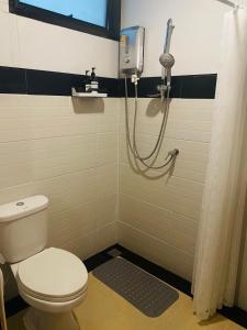 a bathroom with a toilet and a shower at Chern Chiangmai Boutique Hotel in Chiang Mai +50 photos